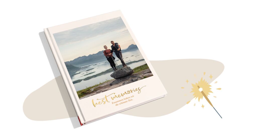 CEWE FOTOBUCH mit Bild eines Paares beim Wandern und dem Titel „Best memories“ mit Goldveredelung